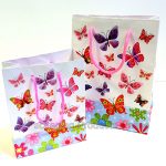 White gift bags with butterflies in all sizes and colours printed all over the bag.